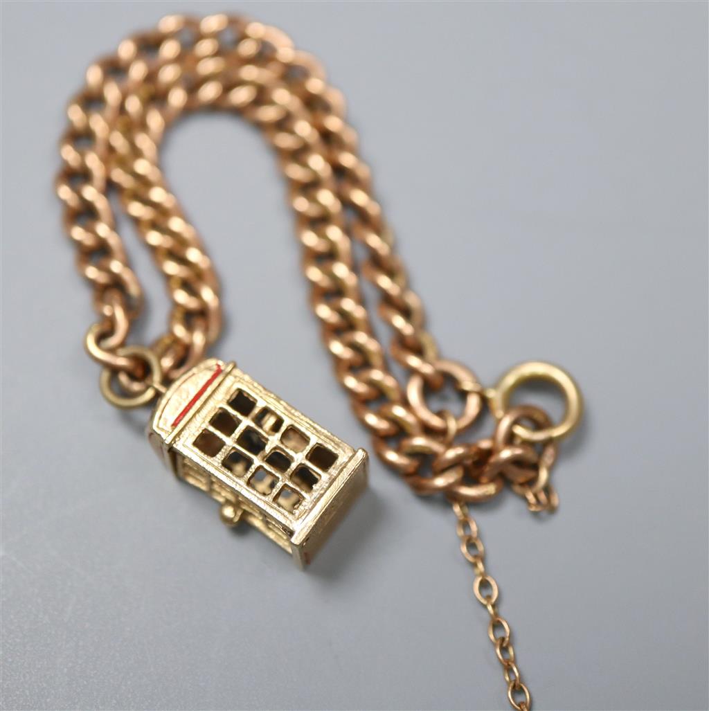 A 9ct gold curb link bracelet, hung with a 9ct gold telephone box charm, gross 12.1 grams.